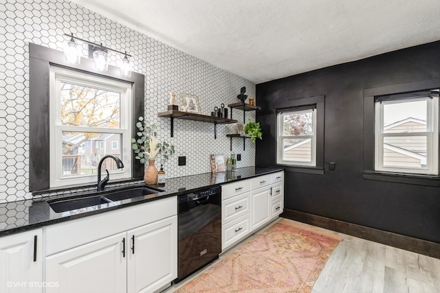 kitchen with black dishwasher, a healthy amount of sunlight, and sink