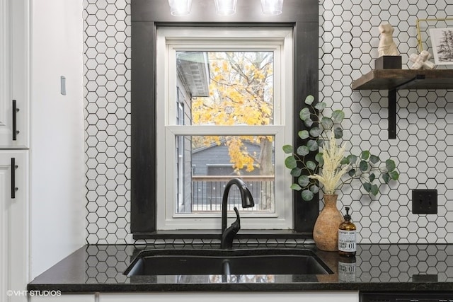 details with white cabinetry, sink, and tasteful backsplash