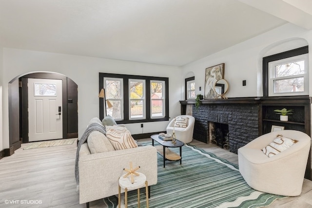 living room featuring a fireplace and light hardwood / wood-style flooring