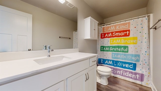 bathroom featuring wood-type flooring, vanity, toilet, and a shower with shower curtain