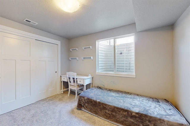 carpeted bedroom featuring a closet