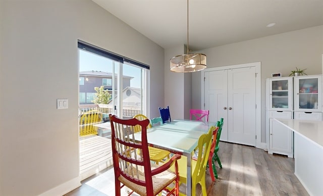 dining area featuring an inviting chandelier and light wood-type flooring