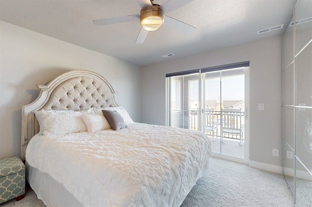 bedroom with a textured ceiling, light carpet, ceiling fan, and access to outside