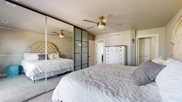 carpeted bedroom with ceiling fan and a closet