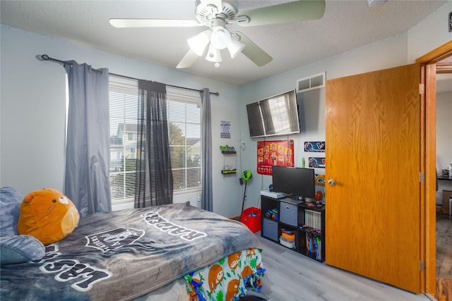 14603 Westbrook Dr, Urbandale, IA 50323 - bedroom with visible vents, light wood finished floors, and ceiling fan