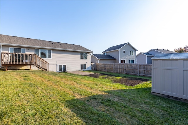 14603 Westbrook Dr, Urbandale, IA 50323 - view of yard featuring a deck, a fenced backyard, an outdoor structure, a patio, and a storage unit