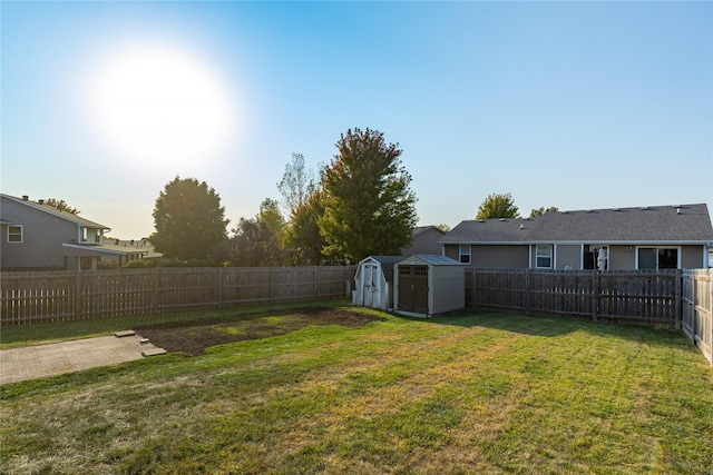 14603 Westbrook Dr, Urbandale, IA 50323 - view of yard featuring a fenced backyard, a storage unit, and an outbuilding