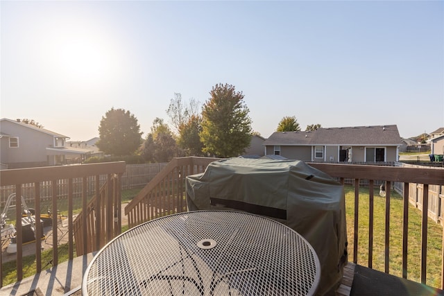14603 Westbrook Dr, Urbandale, IA 50323 - wooden deck featuring a residential view, a fenced backyard, a lawn, outdoor dining area, and area for grilling