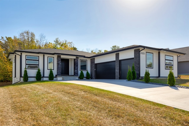 view of front of home with a garage and a front lawn