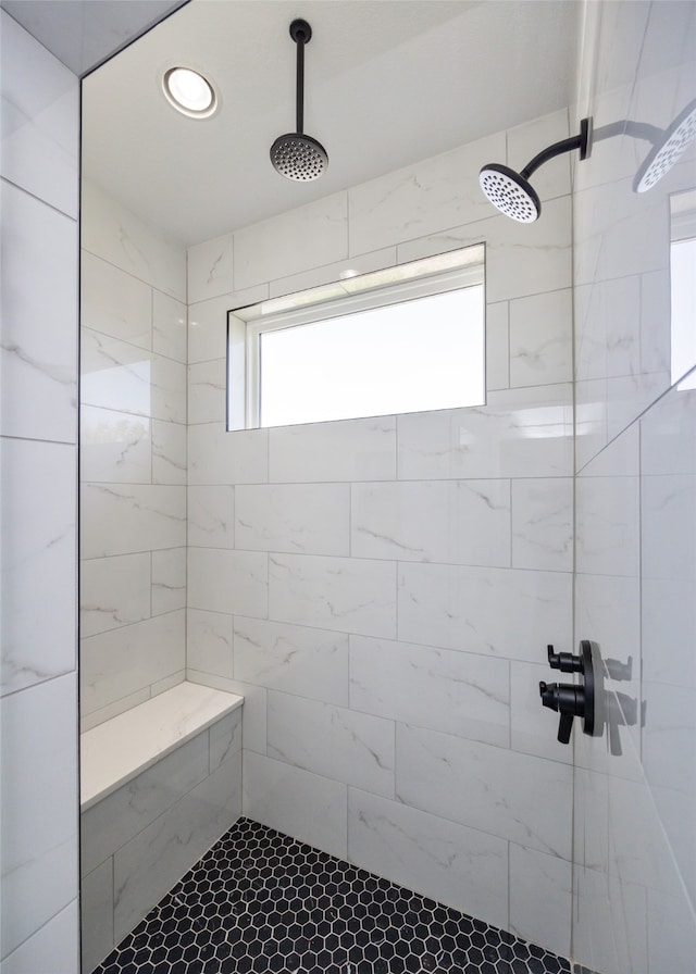 bathroom featuring a tile shower