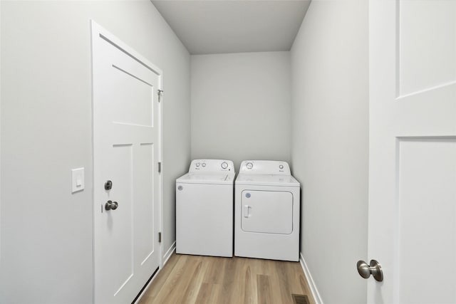 washroom featuring separate washer and dryer and light wood-type flooring