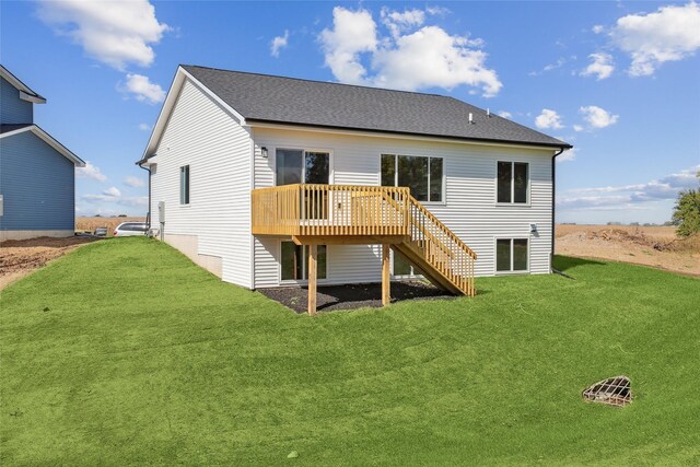 rear view of property featuring a deck and a yard