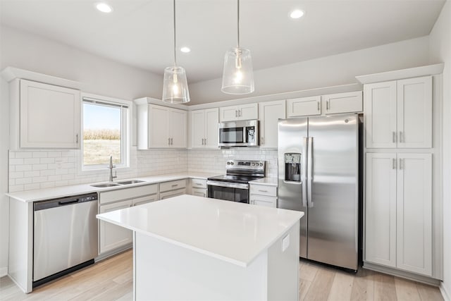 kitchen with light hardwood / wood-style floors, white cabinetry, and stainless steel appliances