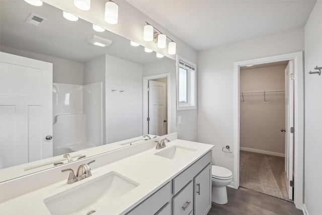 bathroom with vanity, toilet, hardwood / wood-style flooring, and walk in shower