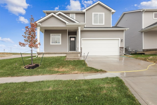 view of front of home featuring a front yard and a garage