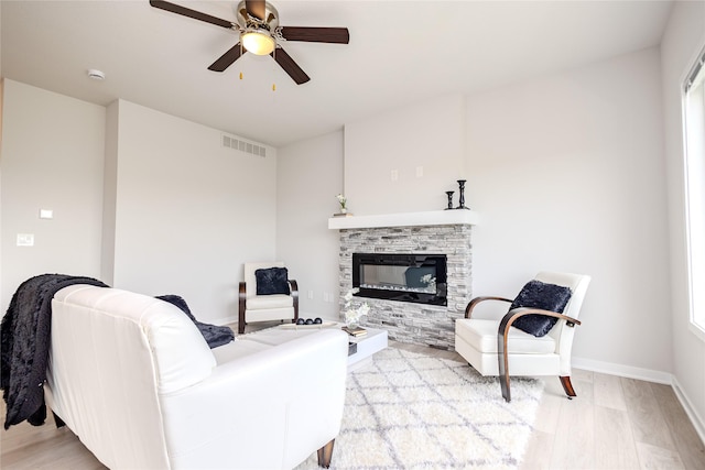 1703 Gordon Ct, Norwalk, IA 50211 - living room featuring a fireplace, ceiling fan, and light wood-type flooring