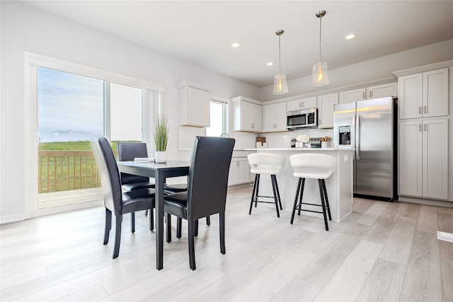 1703 Gordon Ct, Norwalk, IA 50211 - dining room featuring light wood finished floors and recessed lighting