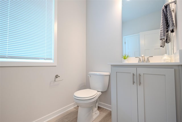 1703 Gordon Ct, Norwalk, IA 50211 - half bath featuring vanity and wood finished floors