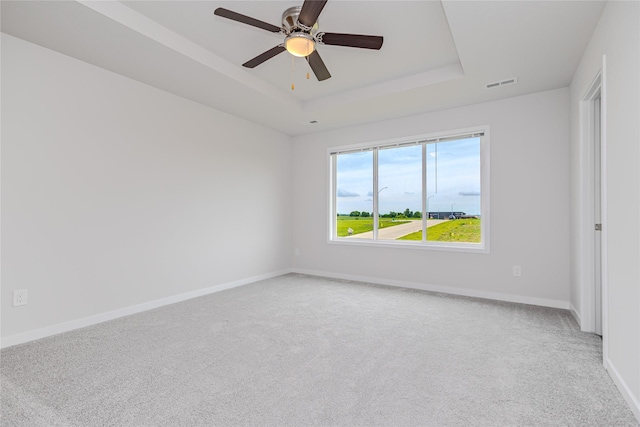 1703 Gordon Ct, Norwalk, IA 50211 - carpeted empty room with a raised ceiling and ceiling fan