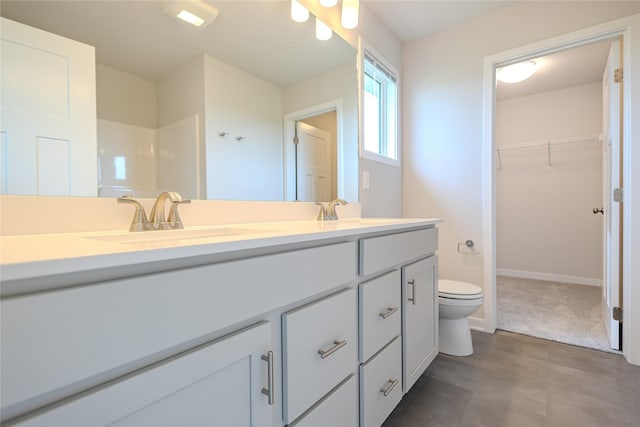 1703 Gordon Ct, Norwalk, IA 50211 - bathroom featuring double vanity and a walk in closet