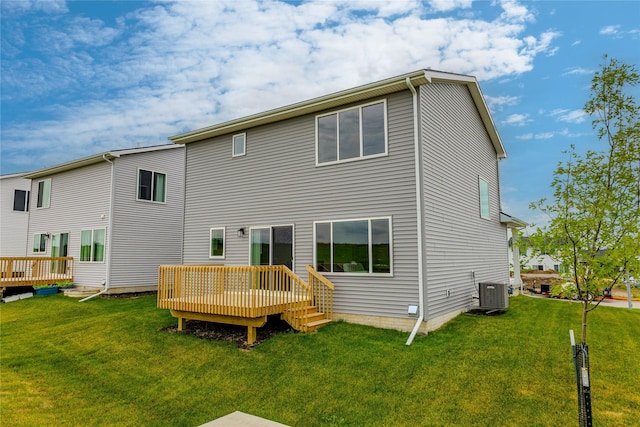1703 Gordon Ct, Norwalk, IA 50211 - back of property with a wooden deck and a lawn