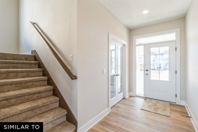 entryway featuring light hardwood / wood-style flooring and french doors