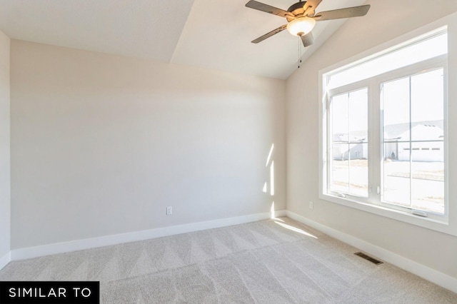 spare room featuring light carpet, ceiling fan, and lofted ceiling