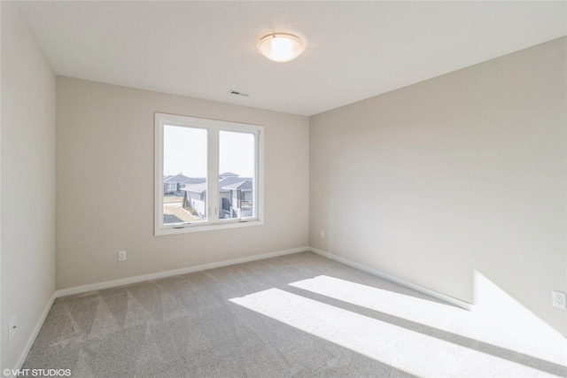 empty room featuring light carpet