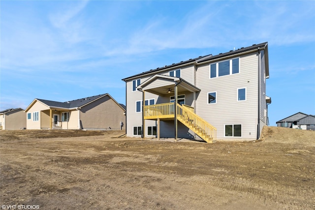 back of house with ceiling fan and a deck