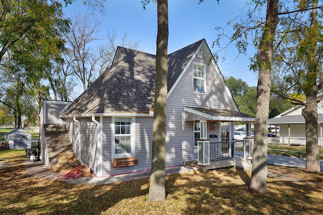 rear view of property with covered porch