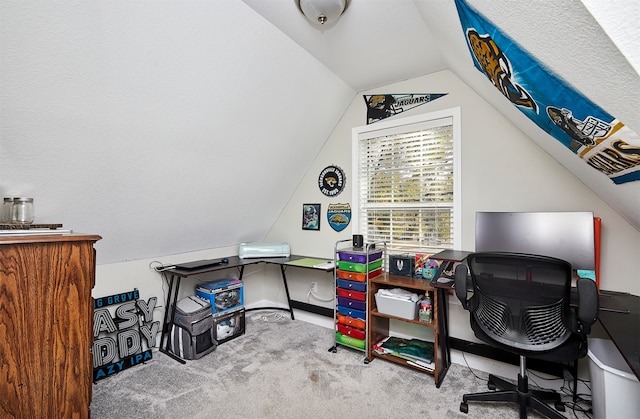 home office featuring lofted ceiling and carpet flooring