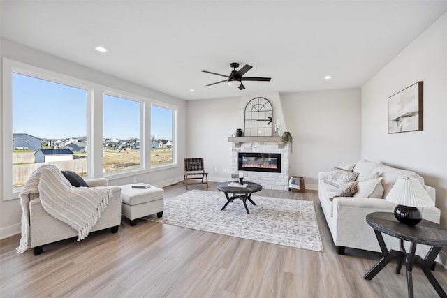 living room with light wood-type flooring and ceiling fan