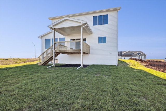 back of property featuring a lawn and a deck