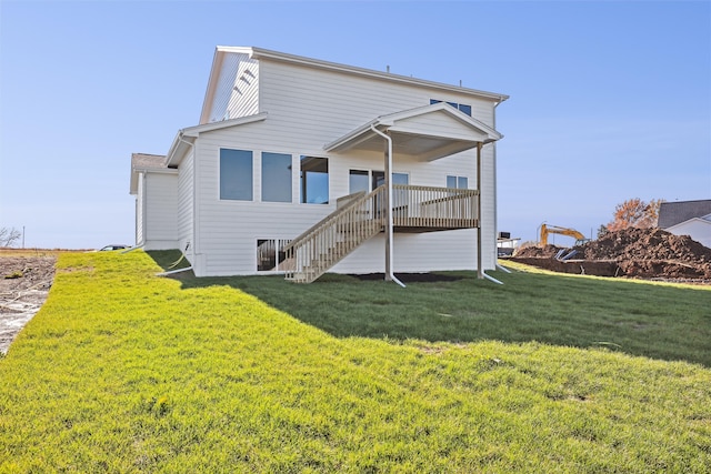 rear view of house with a deck and a lawn