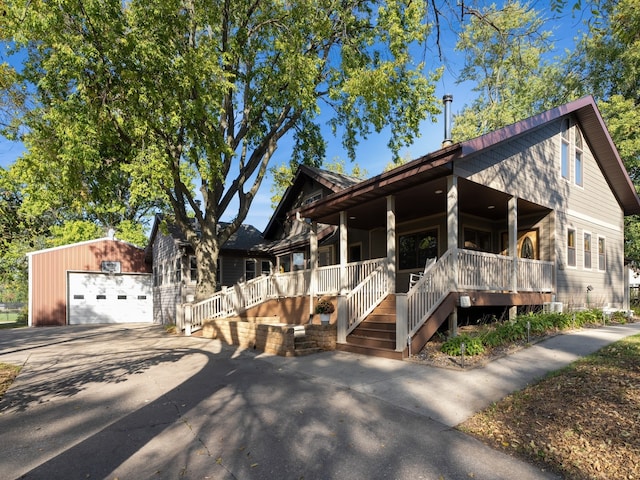 view of front of house with an outdoor structure, covered porch, and a garage