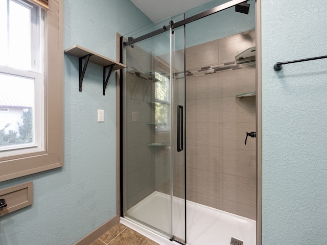 bathroom featuring tile patterned flooring and a shower with door