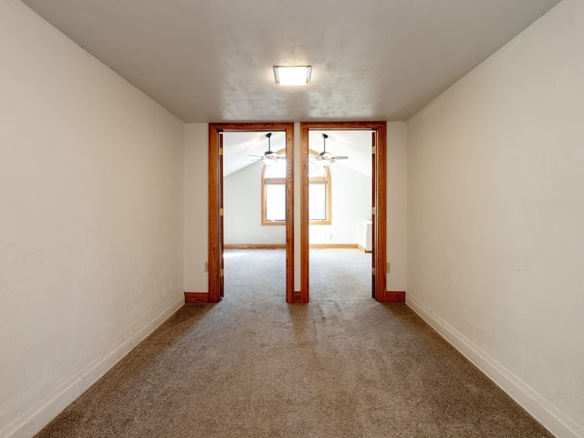 spare room with vaulted ceiling and carpet flooring