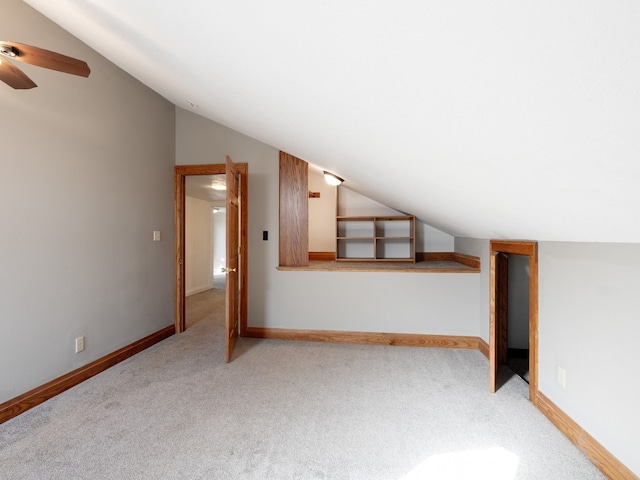 additional living space featuring lofted ceiling and carpet floors