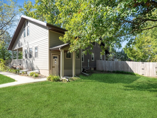 rear view of property with a lawn