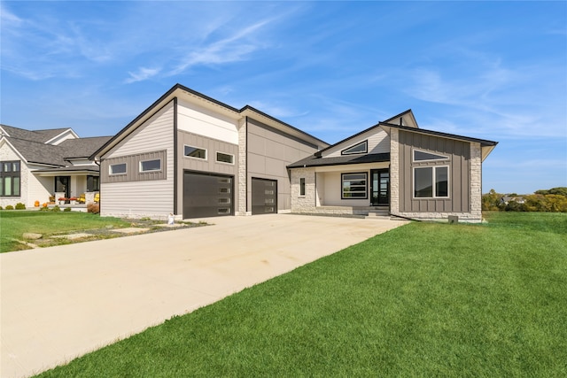 view of front of house with a front yard and a garage