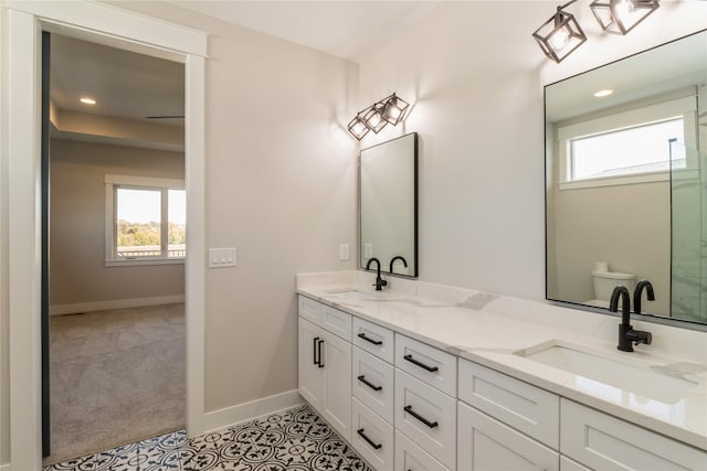 bathroom featuring vanity, toilet, and tile patterned floors