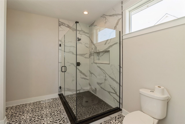 bathroom with tile patterned flooring, toilet, and an enclosed shower