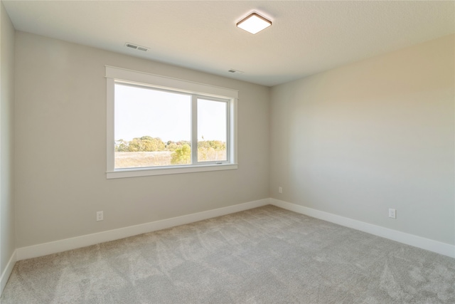 empty room featuring light carpet