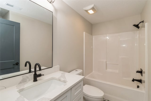 full bathroom featuring bathtub / shower combination, toilet, vanity, and a textured ceiling