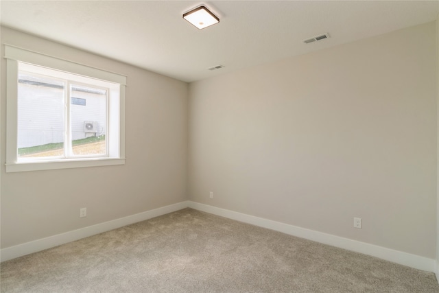 unfurnished room with light carpet