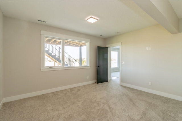 unfurnished room with light carpet