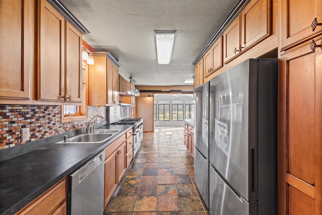 kitchen with hanging light fixtures, sink, tasteful backsplash, ceiling fan, and appliances with stainless steel finishes