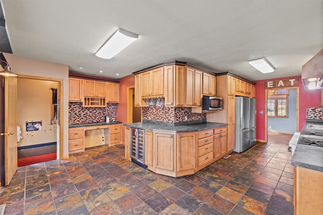 kitchen featuring light brown cabinetry, backsplash, beverage cooler, and stainless steel appliances