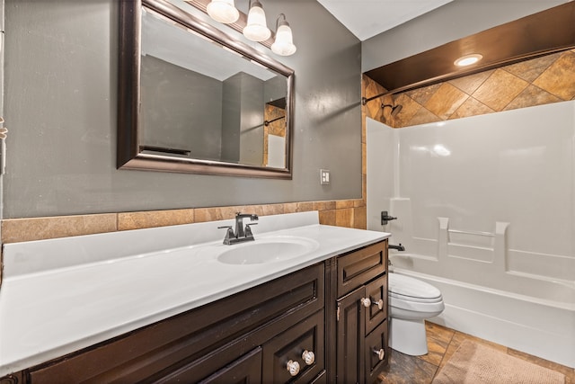 full bathroom with toilet, tiled shower / bath combo, and vanity