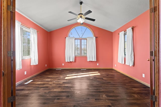 empty room with ceiling fan, lofted ceiling, and dark hardwood / wood-style floors